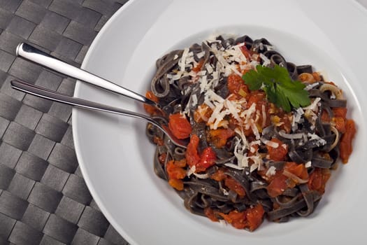 sepia colored tagliatelle with tomato sauce