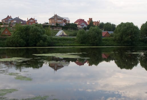 Private houses on the shore of Pakhra-river, Moscow region, Russia