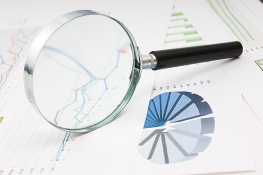 Graphs tables and documents laid on the table