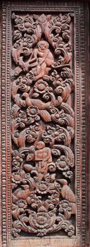 Decorated wooden beside door in Buddhist temple, Laos