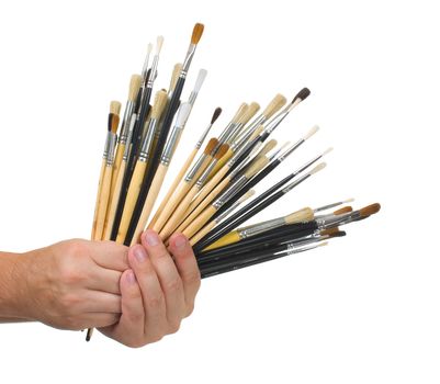 Brushes in hand isolated on white background