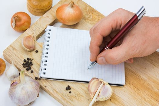 notebook for culinary notes on a cutting board