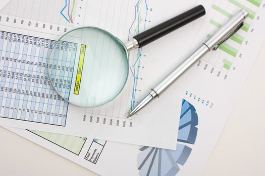 Graphs tables and documents laid on the table