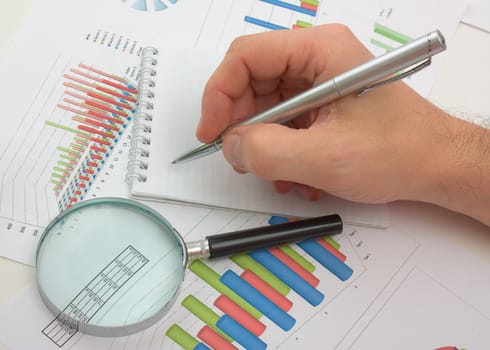 Graphs tables and documents laid on the table