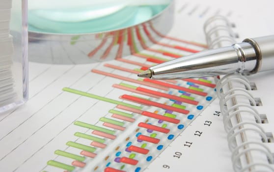 Graphs tables and documents laid on the table