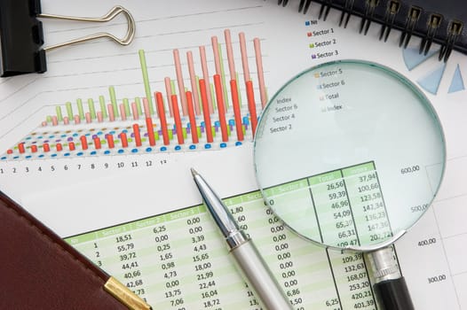 Graphs tables and documents laid on the table