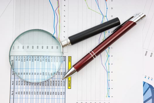 Graphs tables and documents laid on the table