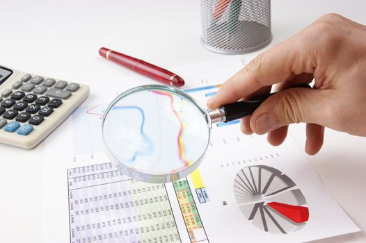 Graphs tables and documents laid on the table