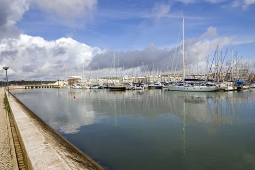 View of the marina with the reflection of clouds in the still water.  Shot in Lagos, Portugal.