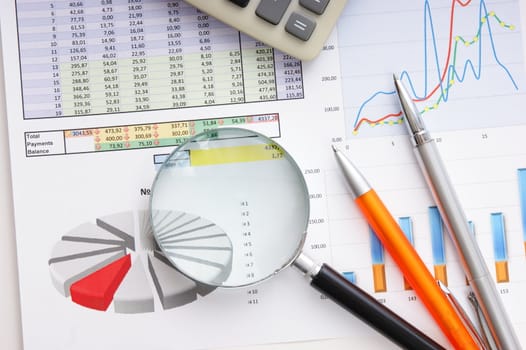 Graphs tables and documents laid on the table