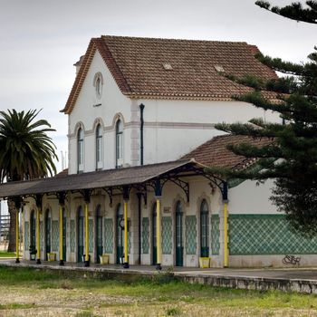 An abandoned railway station with open space in front, where railway tracks once sat.  Lagos, Portugal.