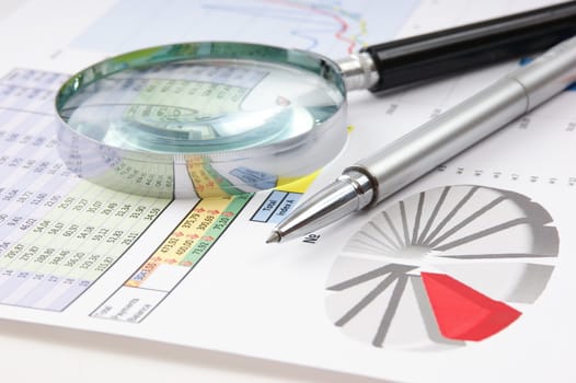 Graphs tables and documents laid on the table