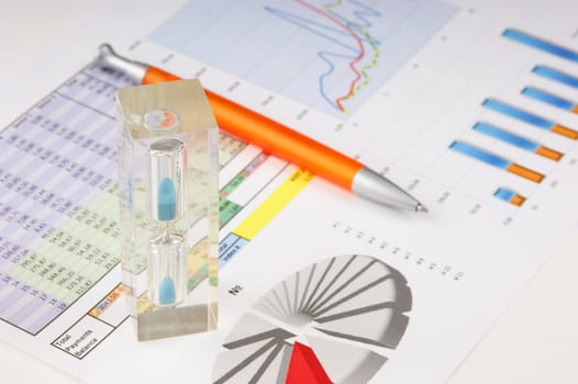 Graphs tables and documents laid on the table