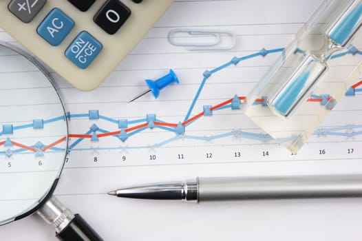 Graphs tables and documents laid on the table