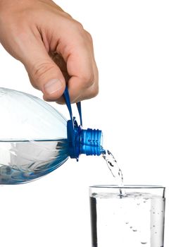 pouring water from a bottle into a glass isolated on white background