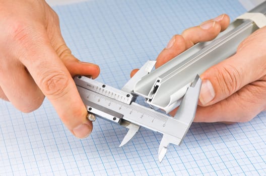 caliper measures the detail on the background of graph paper