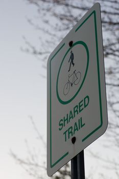 Looking up at a shared trail sign.