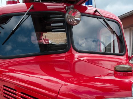 Old red vintage fire truck engine in close view