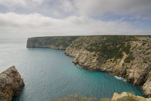A small bay in the Algarve with clear emerald water, on the way to Cape Saint Vincent, Sagres, Portugal.