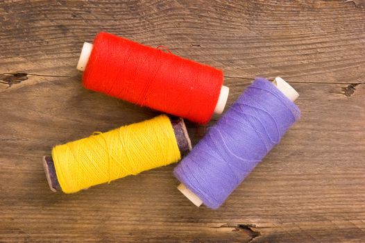 Sewing on the background of the old wooden walls