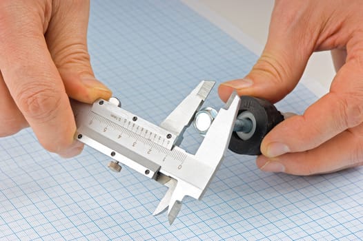 caliper measures the detail on the background of graph paper