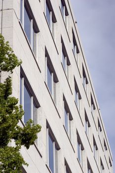 An angled view of a concrete office building.