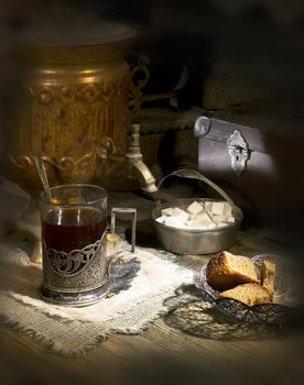 Old samovar on the table with tea and sugar