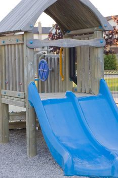 Kids play area, focus on a blue slide.