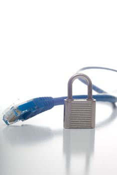 Network Cable end with 2 small key locks behind, reflection visible, isolated on white.