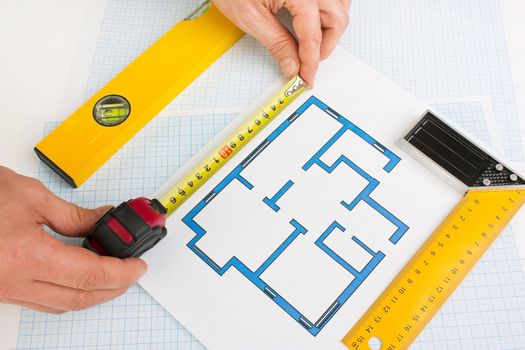 drawing at home with construction tools on a background of graph paper
