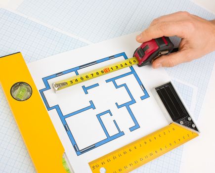 drawing at home with construction tools on a background of graph paper