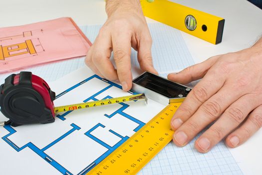 drawing at home with construction tools on a background of graph paper