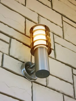 stylish lamp on the stone wall