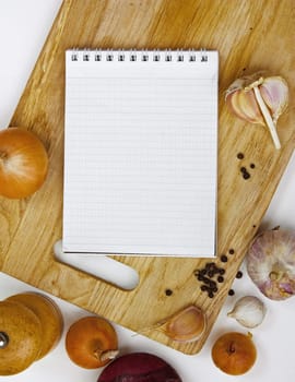notebook for culinary notes on a cutting board