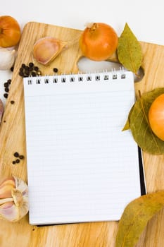 notebook for culinary notes on a cutting board