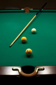 The game of billiards on a table with green cloth