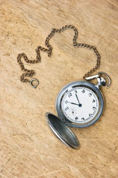 Pocket watch against the old wooden planks 