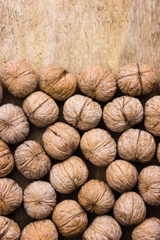 background of walnuts on an old wooden board