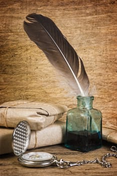 Postage on the background of an old wooden board with a pen for writing in the ink