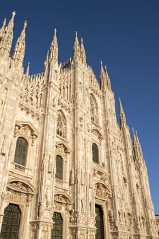 Gothic facade of Milan Cathedral in Piazza del Duomo. It is the fourth largest church in the world. The construction started in 1386 and took about five centuries.