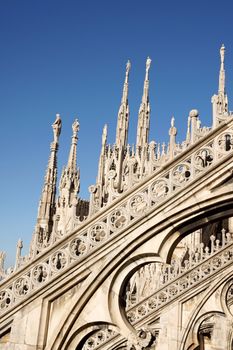 Detail of the gothic Milan Cathedral in Piazza del Duomo. It is the fourth largest church in the world. The construction started in 1386 and took about five centuries. This detail was taken from the roof and refers to the upper left side of the Cathedral.