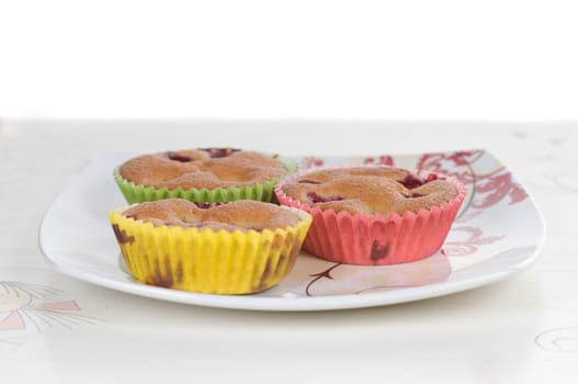 Cup-cakes on the table decorated with cherry