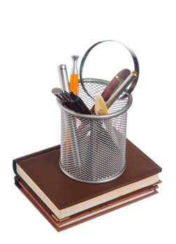 basket with pens and pencils isolated on a white background