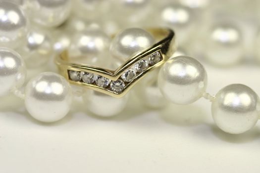 string of pearls with a wishbone diamond engagement ring