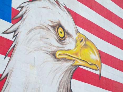 graffiti of an eagle with the american flag in the background