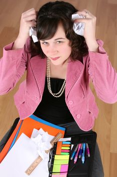 Frustrated business woman sitting on a wooden floor