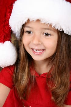 Cute brunette girl wearing a fluffy christmas hat
