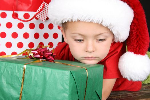 Little boy with big blue eyes wearing a christmas hat 