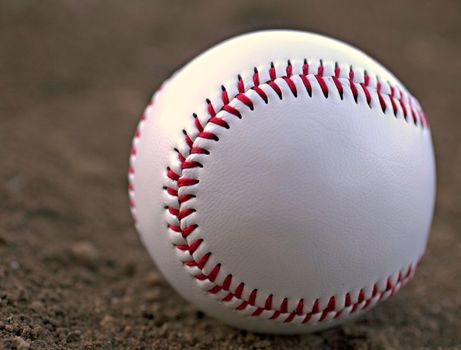 Closeup of a Baseball Sitting in Infield Dirt