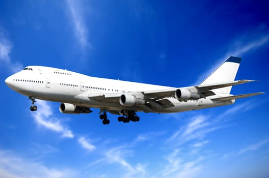 Jumbo jet and blue and cloudy sky.